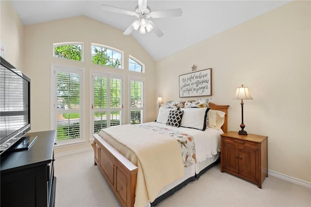 bedroom featuring baseboards, light colored carpet, ceiling fan, and vaulted ceiling