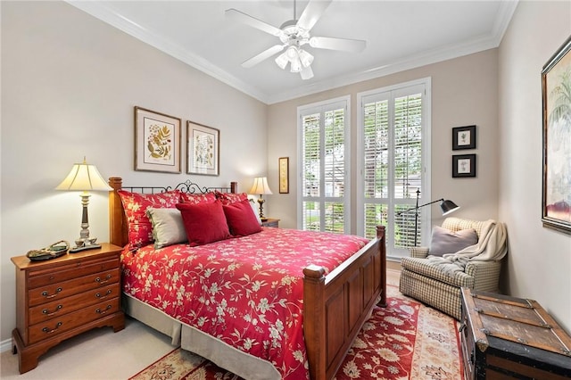 bedroom featuring crown molding, a ceiling fan, baseboards, and light carpet