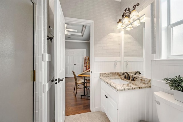 full bathroom with crown molding, vanity, a decorative wall, toilet, and an enclosed shower