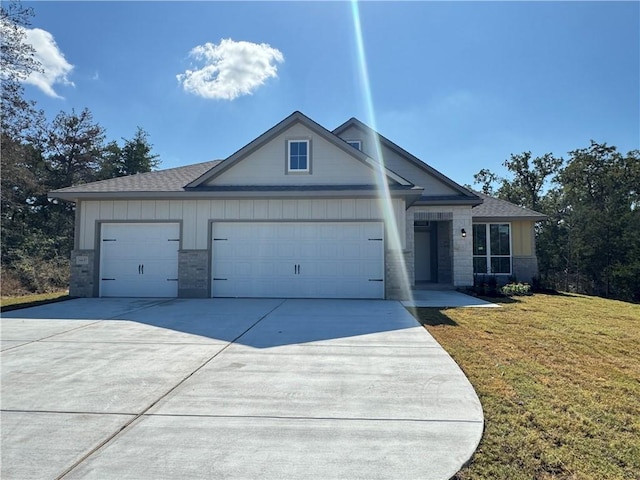 view of front of home with a front yard and a garage