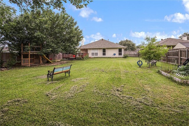 view of yard featuring a playground and a wooden deck