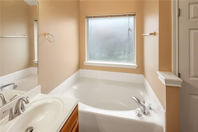 full bathroom with a garden tub and vanity