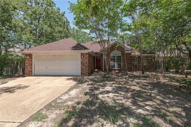 705 Summerglen Dr, College Station, TX 77840 - ranch-style house featuring concrete driveway, an attached garage, brick siding, and a shingled roof