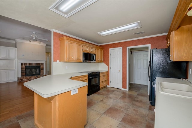 705 Summerglen Dr, College Station, TX 77840 - kitchen with black appliances, a peninsula, ceiling fan, ornamental molding, and light countertops