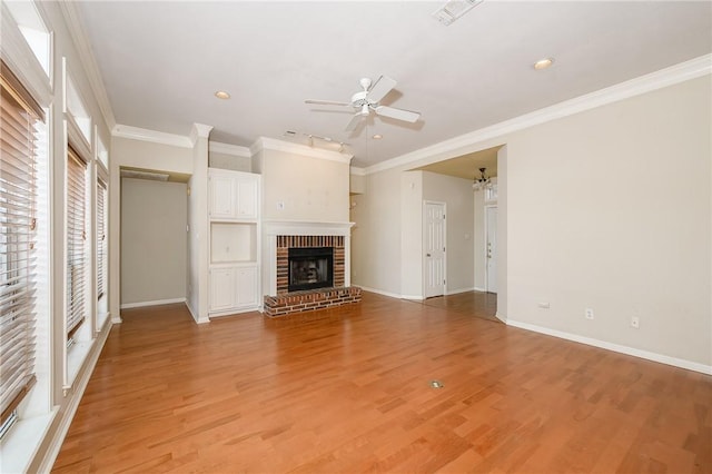 705 Summerglen Dr, College Station, TX 77840 - unfurnished living room with a ceiling fan, crown molding, light wood-style floors, a fireplace, and recessed lighting