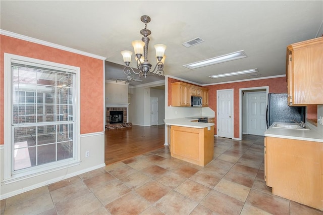 705 Summerglen Dr, College Station, TX 77840 - kitchen featuring freestanding refrigerator, stainless steel microwave, a chandelier, crown molding, and light countertops
