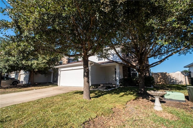 view of front of home featuring a front yard and a garage