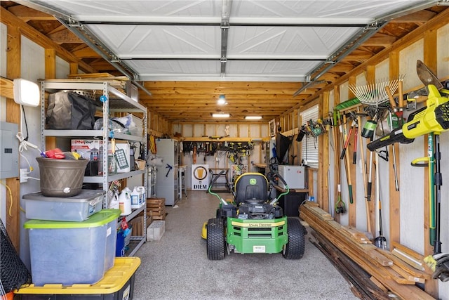 garage with electric panel and a workshop area