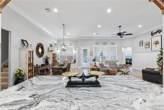 living room featuring hardwood / wood-style flooring, ceiling fan, and ornamental molding