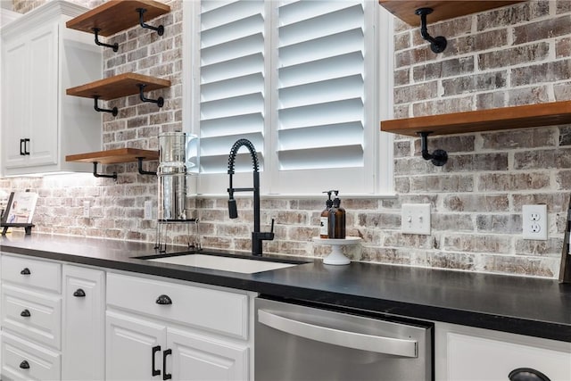 kitchen with stainless steel dishwasher, white cabinets, and sink