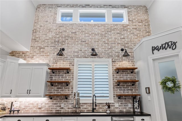 kitchen with white cabinets, dishwasher, and sink