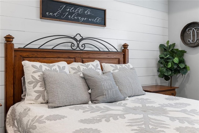 bedroom featuring wood walls