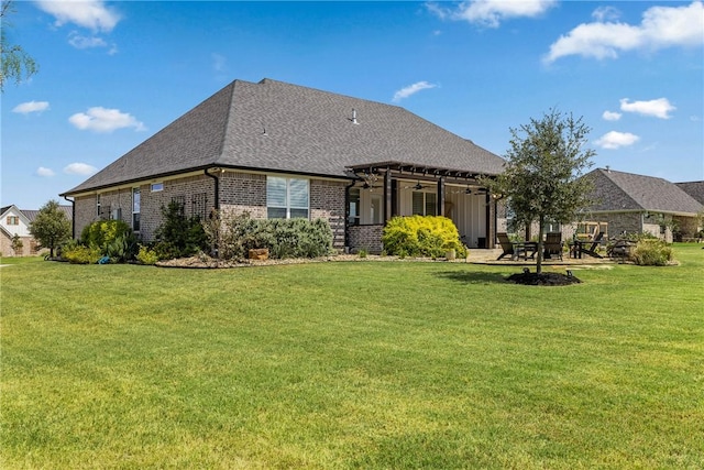 back of house featuring a pergola and a yard