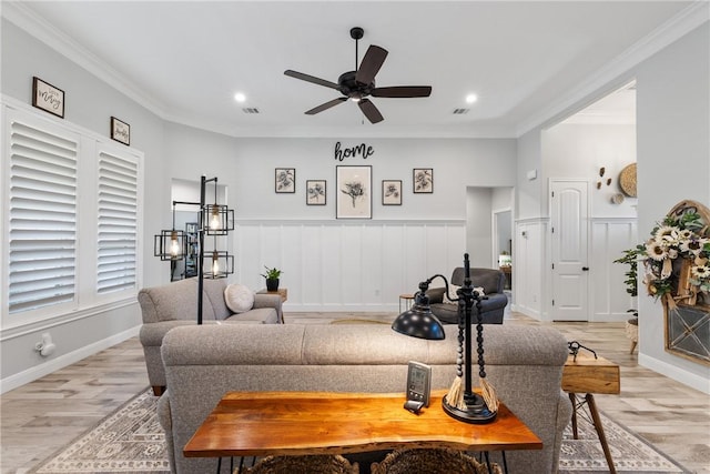 living room featuring ceiling fan, light hardwood / wood-style flooring, and ornamental molding