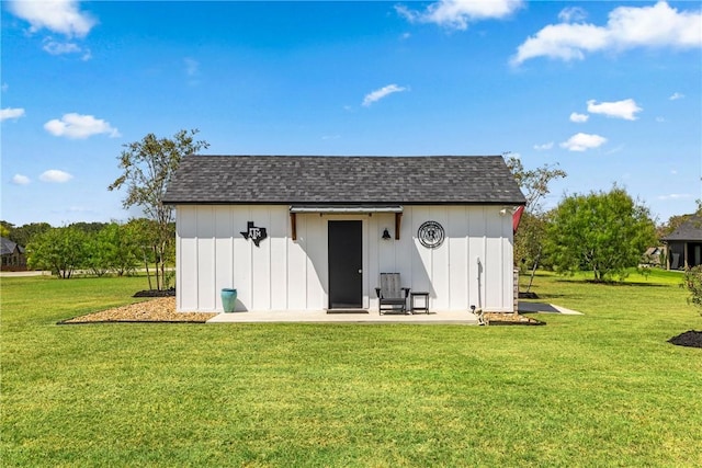 view of outbuilding featuring a lawn