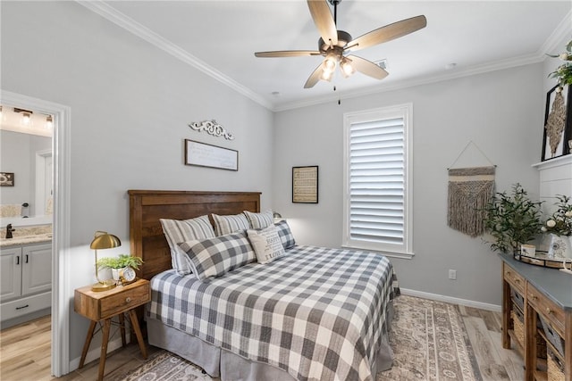 bedroom featuring light wood-type flooring, connected bathroom, ceiling fan, and crown molding