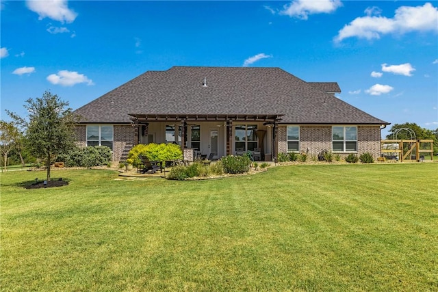 rear view of house featuring a lawn