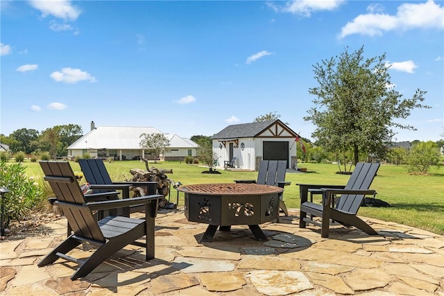 view of patio / terrace featuring a fire pit and a storage shed