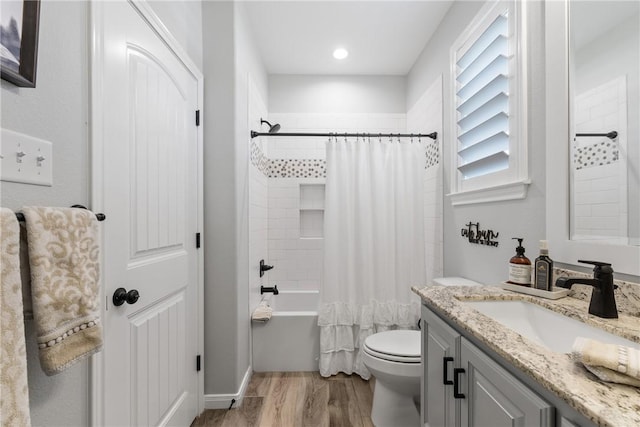 full bathroom featuring shower / bath combination with curtain, vanity, hardwood / wood-style flooring, and toilet