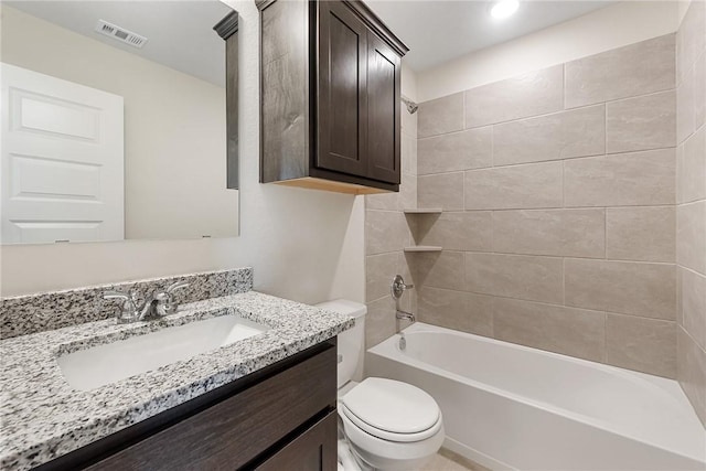 full bathroom with vanity, toilet, and tiled shower / bath