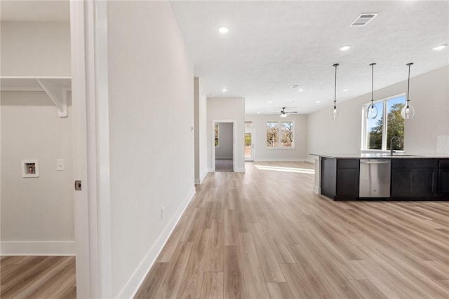 kitchen featuring sink, stainless steel dishwasher, ceiling fan, decorative light fixtures, and light hardwood / wood-style floors