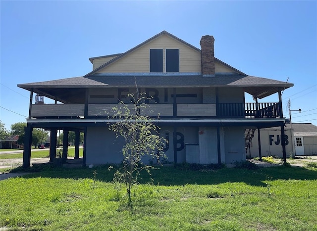409 S Ave, C, TX 77541 - back of property featuring a lawn, a chimney, a shingled roof, and a balcony