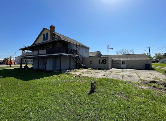 409 S Ave, C, TX 77541 - rear view of property with stairs, a yard, and a chimney