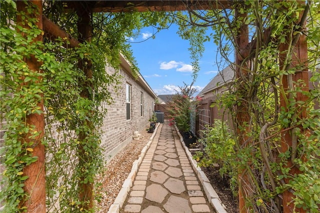 4004 Wild Creek Ct, College Station, TX 77845 - view of side of home with brick siding and a central air condition unit