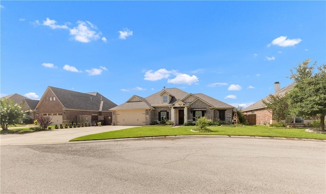 4004 Wild Creek Ct, College Station, TX 77845 - view of front of house featuring driveway, a front yard, a garage, a residential view, and brick siding