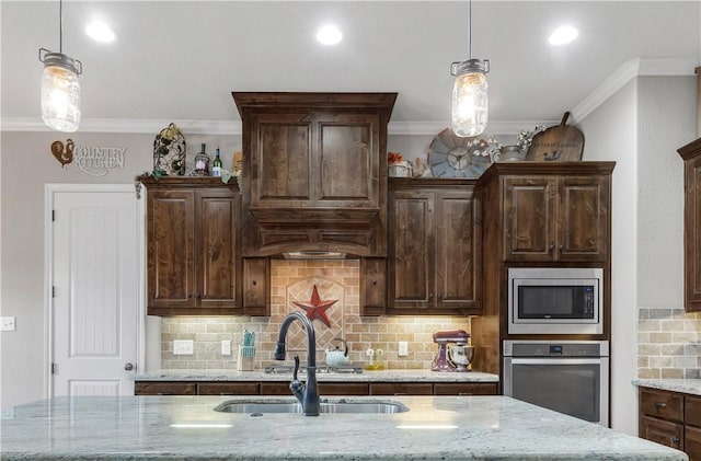4004 Wild Creek Ct, College Station, TX 77845 - kitchen featuring stainless steel appliances, crown molding, tasteful backsplash, dark brown cabinets, and light stone counters