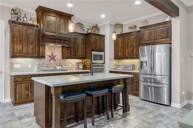 4004 Wild Creek Ct, College Station, TX 77845 - kitchen featuring stainless steel appliances, ornamental molding, backsplash, pendant lighting, and an island with sink