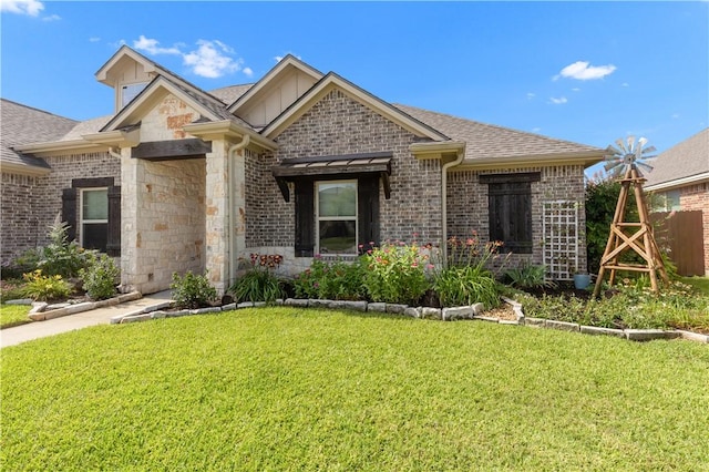 4004 Wild Creek Ct, College Station, TX 77845 - view of front facade featuring stone siding, a shingled roof, brick siding, and board and batten siding
