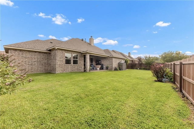 4004 Wild Creek Ct, College Station, TX 77845 - back of property with a fenced backyard, brick siding, a patio area, and a chimney