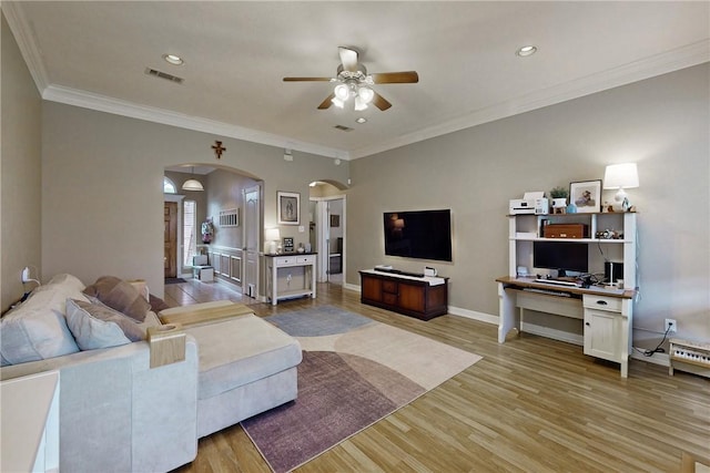 living room featuring light hardwood / wood-style floors, ceiling fan, and ornamental molding