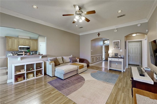 living room featuring ceiling fan, light hardwood / wood-style floors, and crown molding