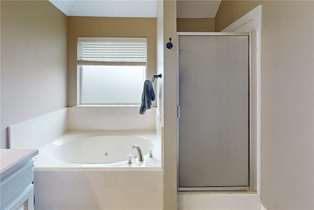 bathroom with vanity, separate shower and tub, and vaulted ceiling