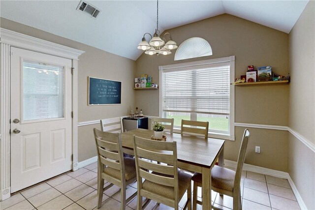 dining space featuring light tile patterned flooring, a chandelier, and vaulted ceiling