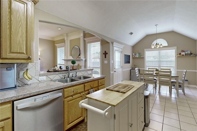 kitchen with sink, plenty of natural light, stainless steel dishwasher, and an inviting chandelier