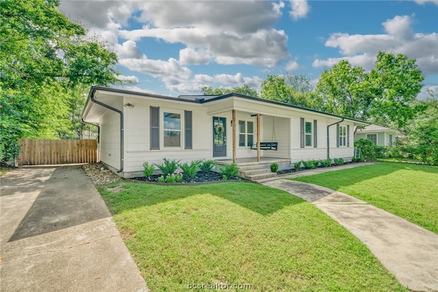 single story home featuring covered porch and a front lawn