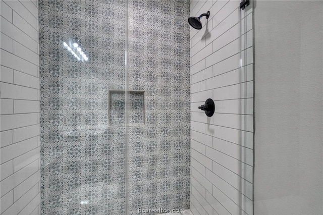 bathroom with a tile shower