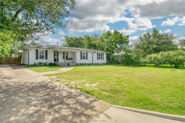 ranch-style home with covered porch and a front yard