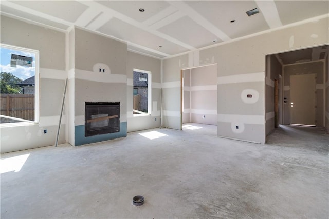 unfurnished living room featuring concrete flooring