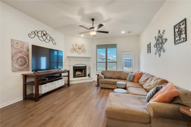 living room featuring hardwood / wood-style floors and ceiling fan