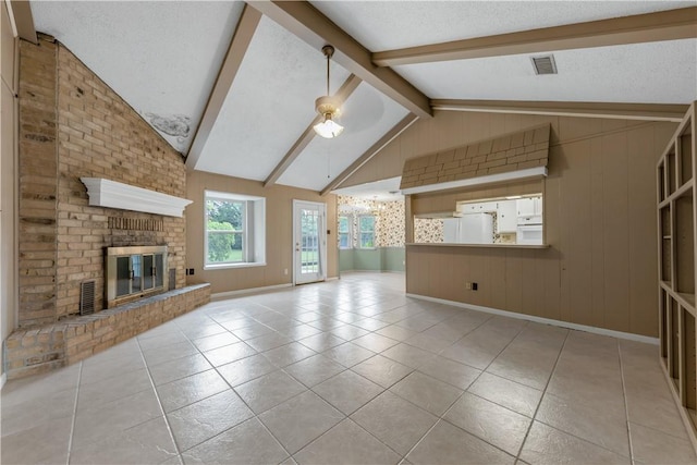 2100 Langford St, College Station, TX 77840 - unfurnished living room featuring tile patterned floors, a textured ceiling, a brick fireplace, and a ceiling fan