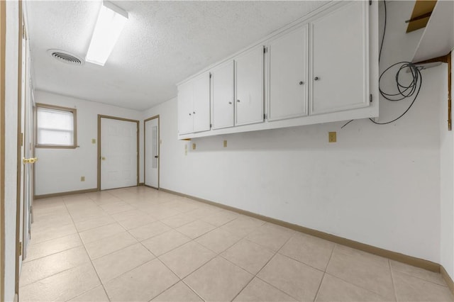 2100 Langford St, College Station, TX 77840 - unfurnished room featuring a textured ceiling and light tile patterned floors