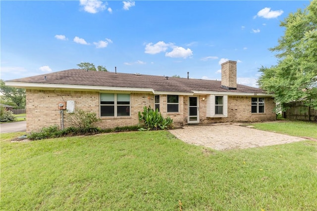 2100 Langford St, College Station, TX 77840 - back of house with a chimney, a patio, and brick siding