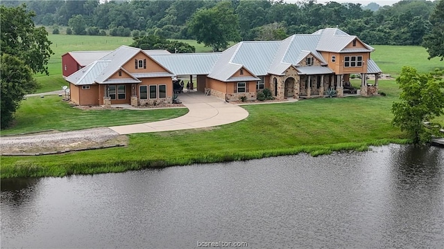 exterior space featuring a front yard and a water view