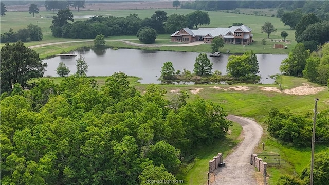 birds eye view of property featuring a water view and a rural view