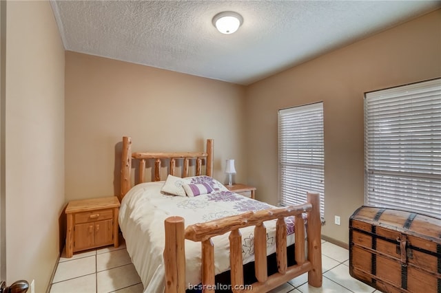 tiled bedroom featuring a textured ceiling