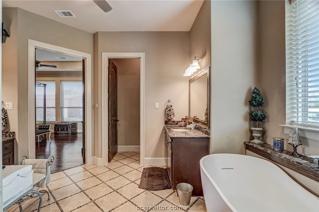 bathroom with hardwood / wood-style flooring, vanity, a bathtub, and ceiling fan